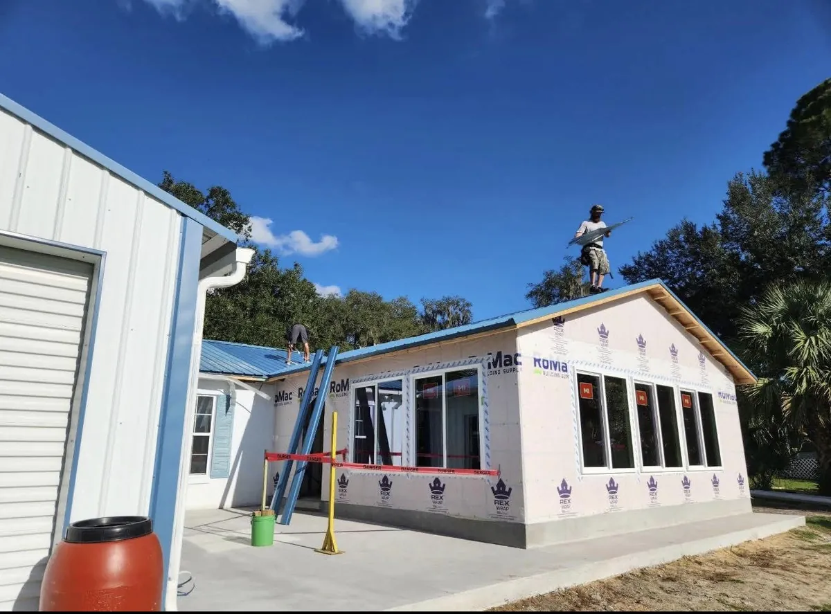 Destination Roofing crew installing a blue metal roof in Lecanto, Florida