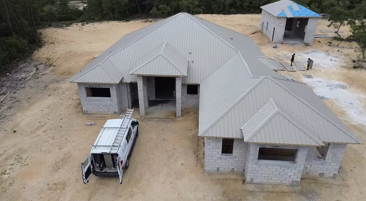 Tan standing-seam metal roof installed on a new-construction home in Pine Ridge, Florida
